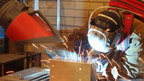 A welder with protective gear. 