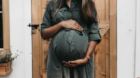 Pregnant lady holding her belly