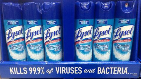 Bottles of Lysol cleaning spray lined up on a shelf