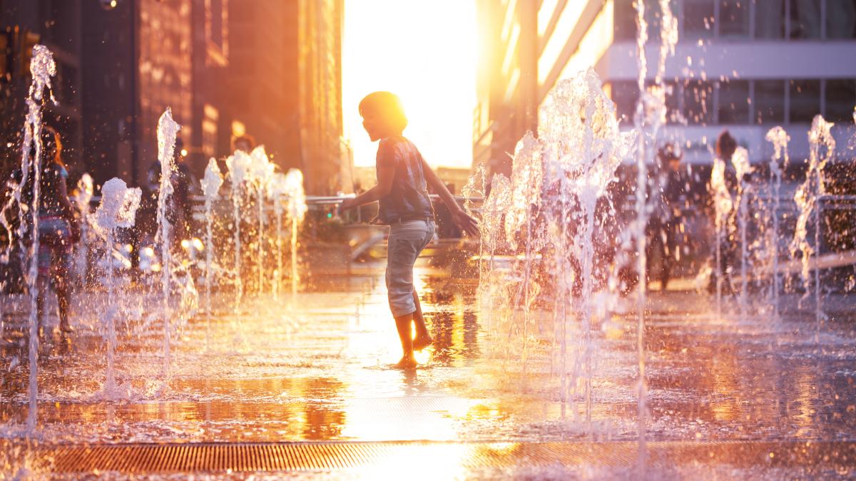 Child playing in water on a hot day