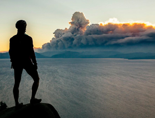 man looking at smoke