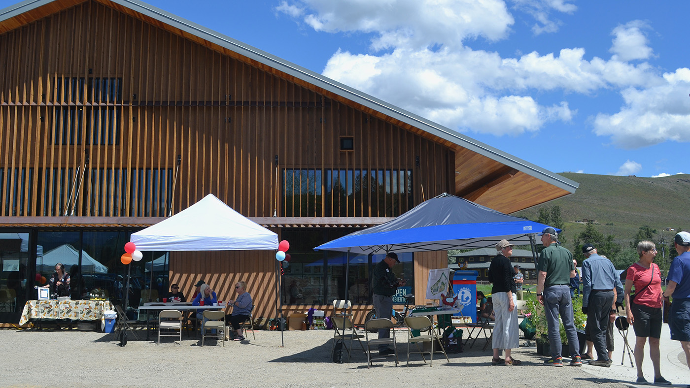 Several informational tables are set up outside the new Winthrop public library building. 