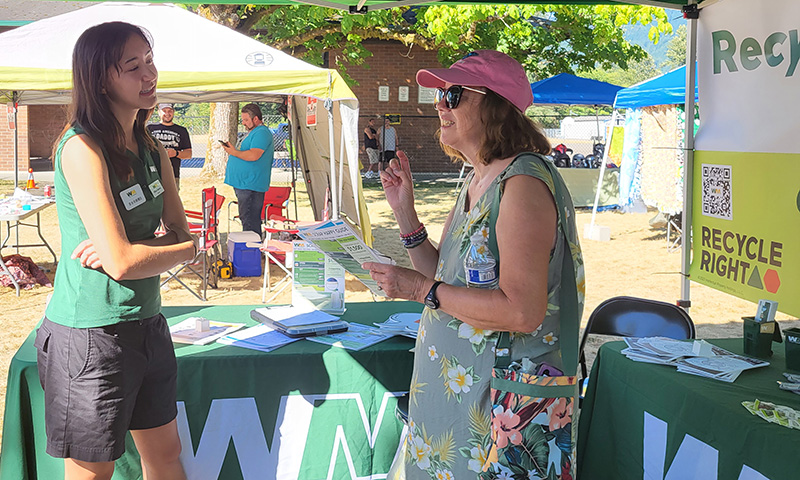 Allison talking to a customer at a fair