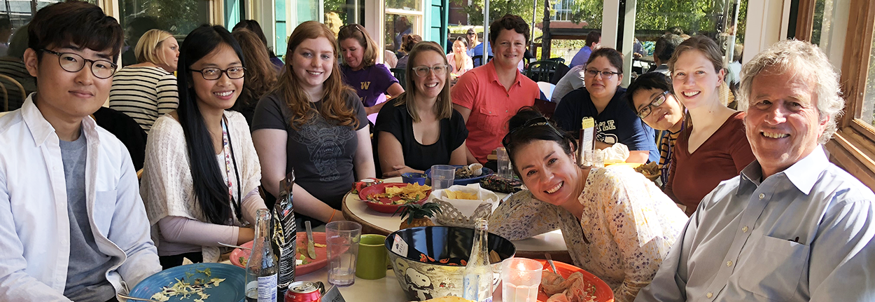 Ten people sit at a restaurant table (Burbacher and his students).