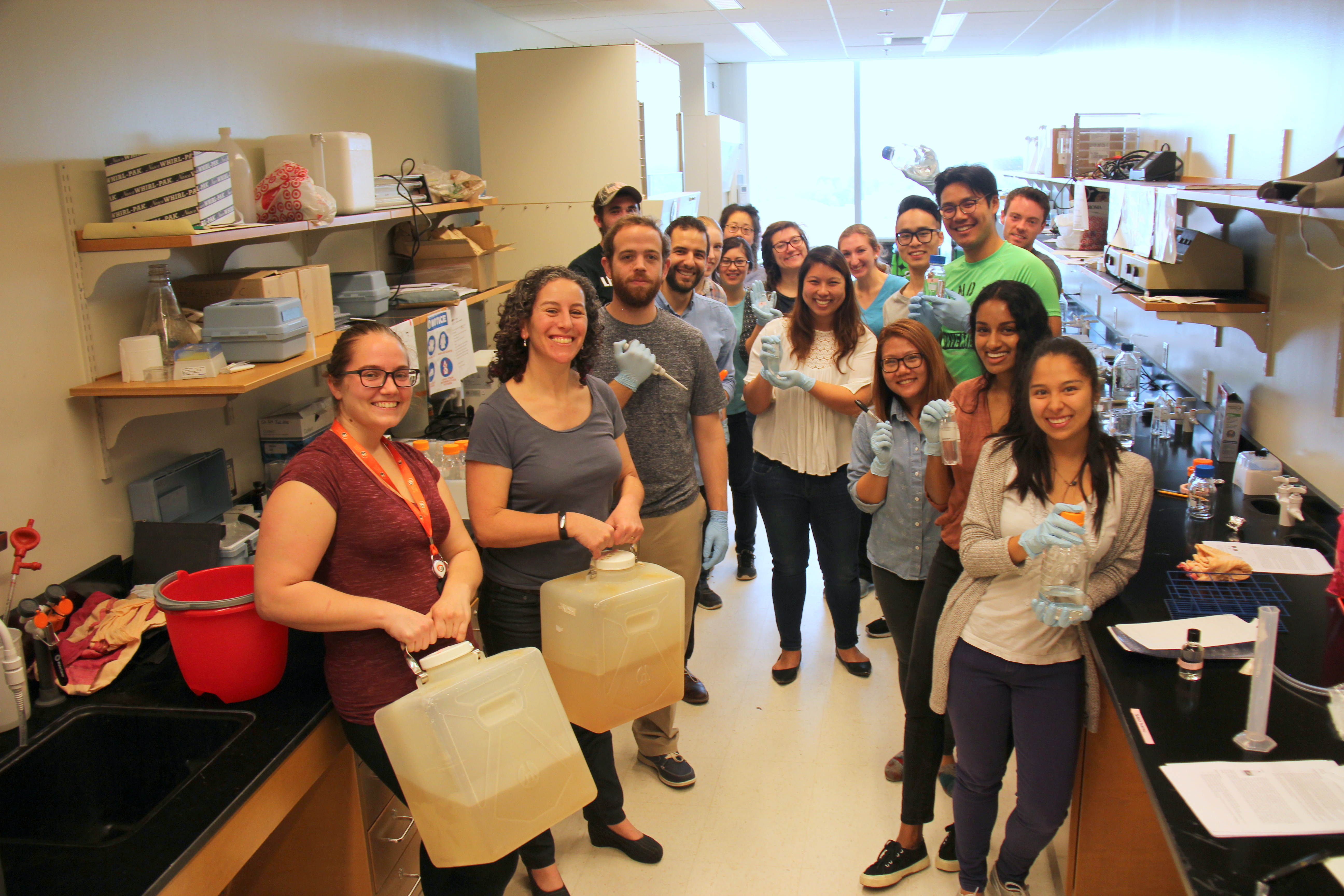 A group of people standing in a university lab.