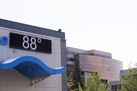 Building with a sign saying '88' degrees. 