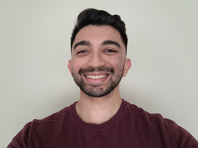 Pranav Srikanth smiles wearing a burgundy shirt.