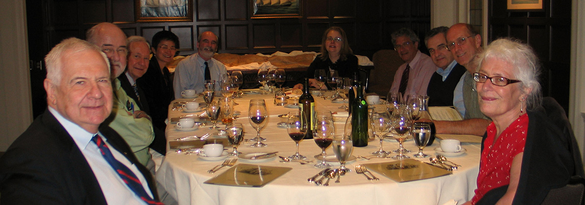 Photo of a group of people sitting around a dinner table.