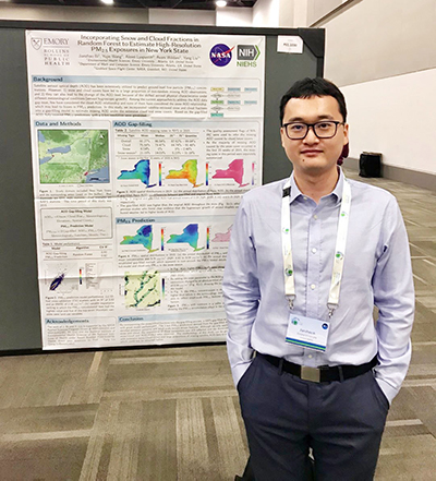 Man standing in front of research poster.