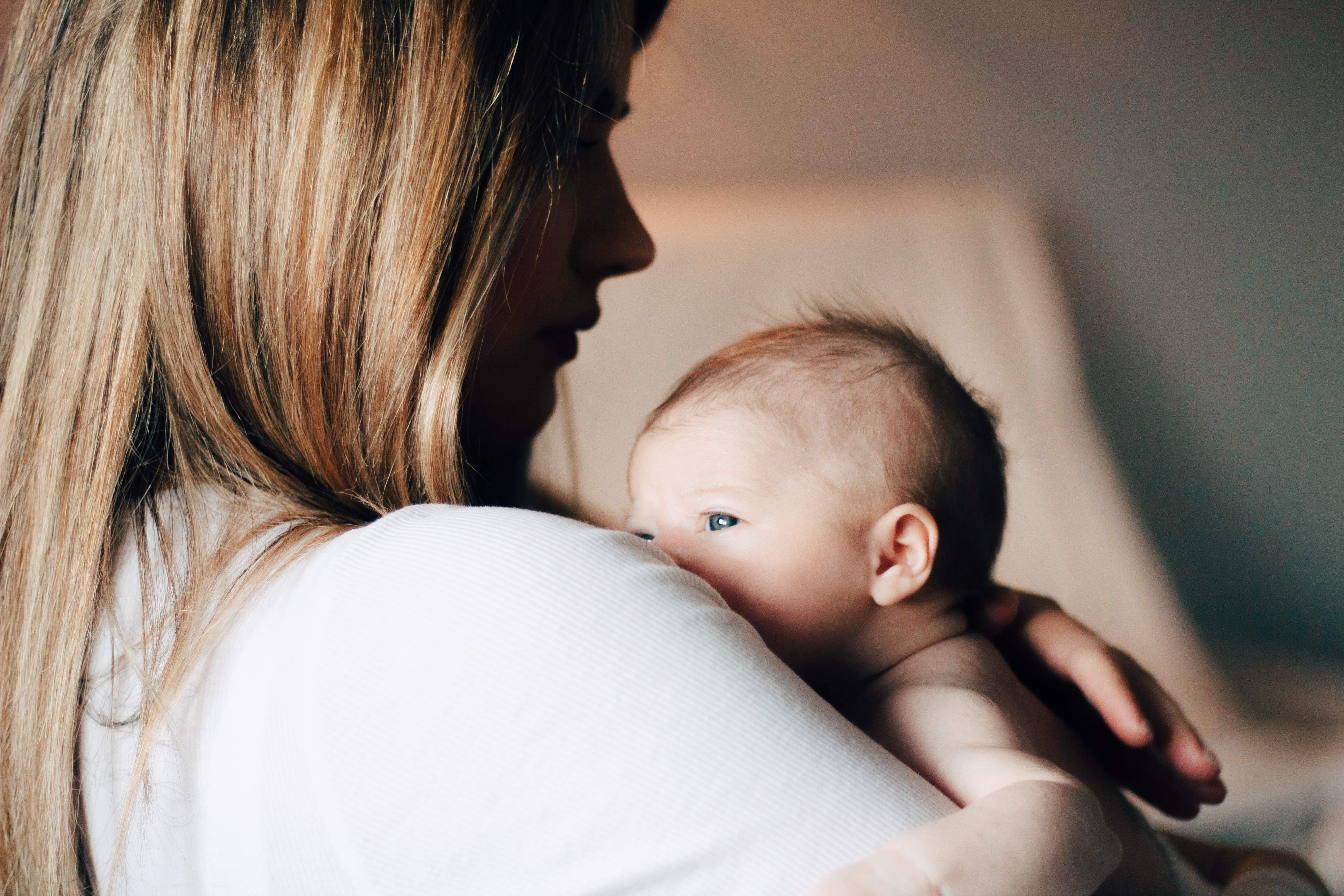 A woman holds a baby.