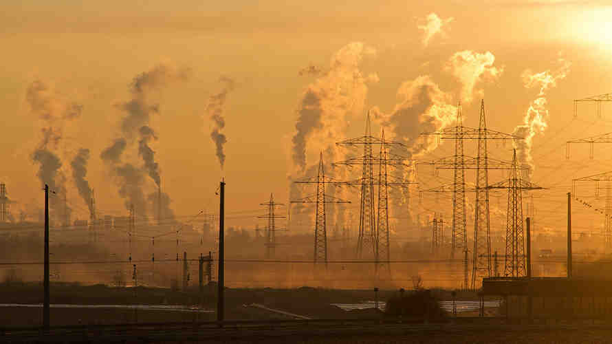 image of an industrial district encased in smog with many power lines running through.