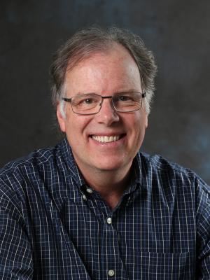 Headshot of Jerry who is an older white man with salt and pepper hair