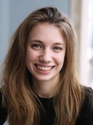 Woman with long, light brown hair and black shirt