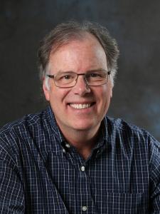 Headshot of Jerry who is an older white man with salt and pepper hair