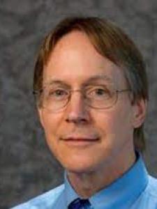 Headshot of Bruce Duncan, a middle-aged white man with longish brown hair and glasses