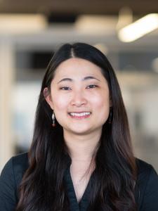 Headshot of Esther, a young Asian woman with long hair