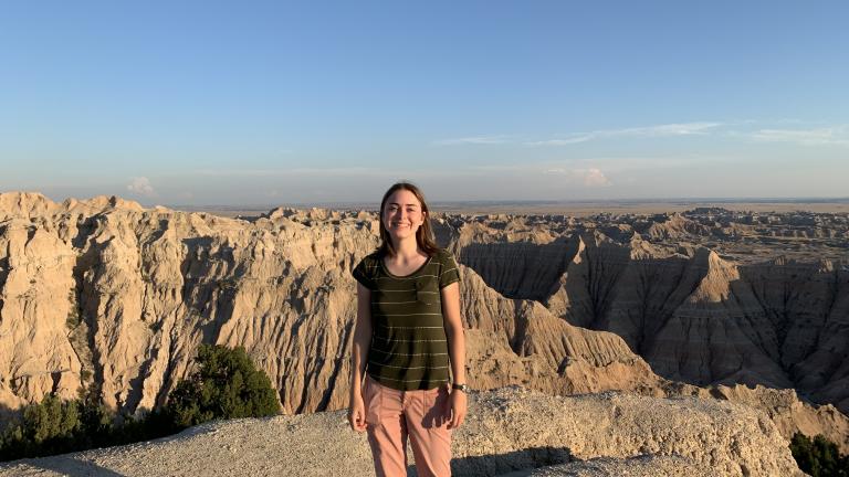 Peterson standing in front of a canyon in the Badlands.