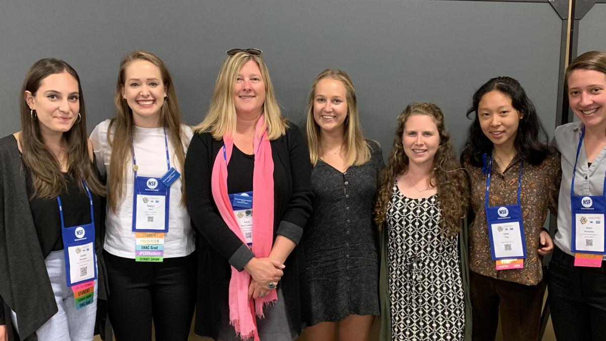 A group of students and faculty pose for a photo.