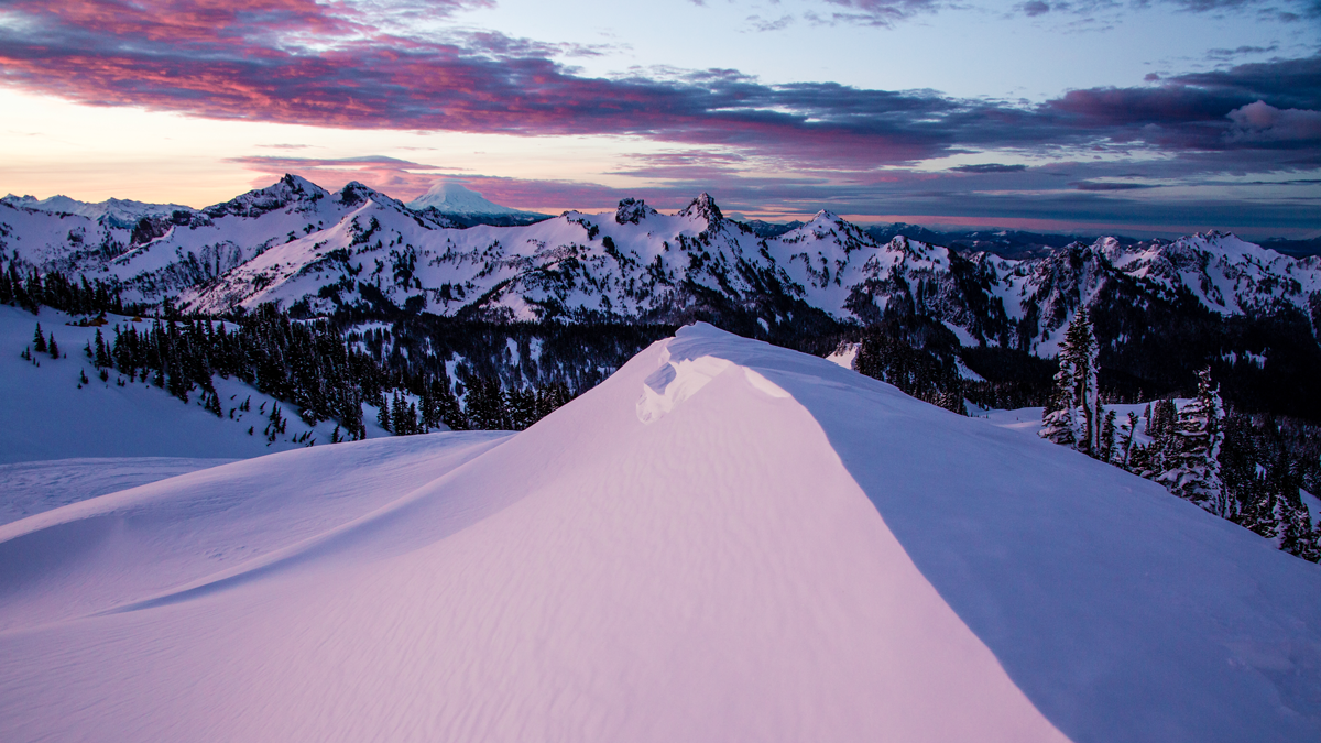 Purple and blue sunset over snowy mountains 