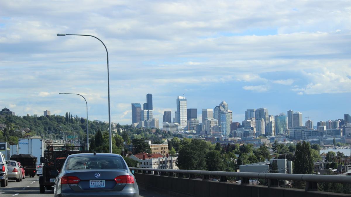 cars driving into a city