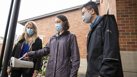 Elena Austin explaining study to Tina Orwell and SeaTac deputy mayor