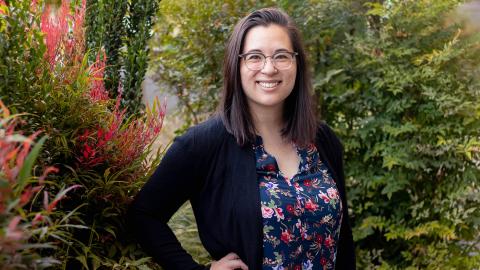 Photo of Shelley Stephan smiling outside with plants in the background.