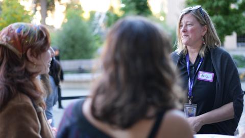 Tania Busch Isaksen talks with students outside on the UW campus.