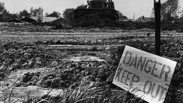 Danger sign in front of contaminated land